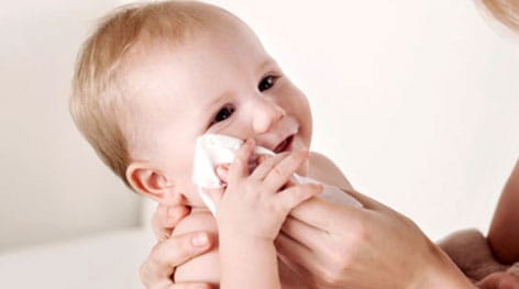 Gentle baby care wet wipes being used for infant cleaning