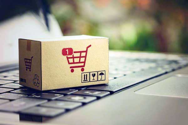 Miniature shipping box on laptop keyboard representing wet wipes private label for e-commerce brands
