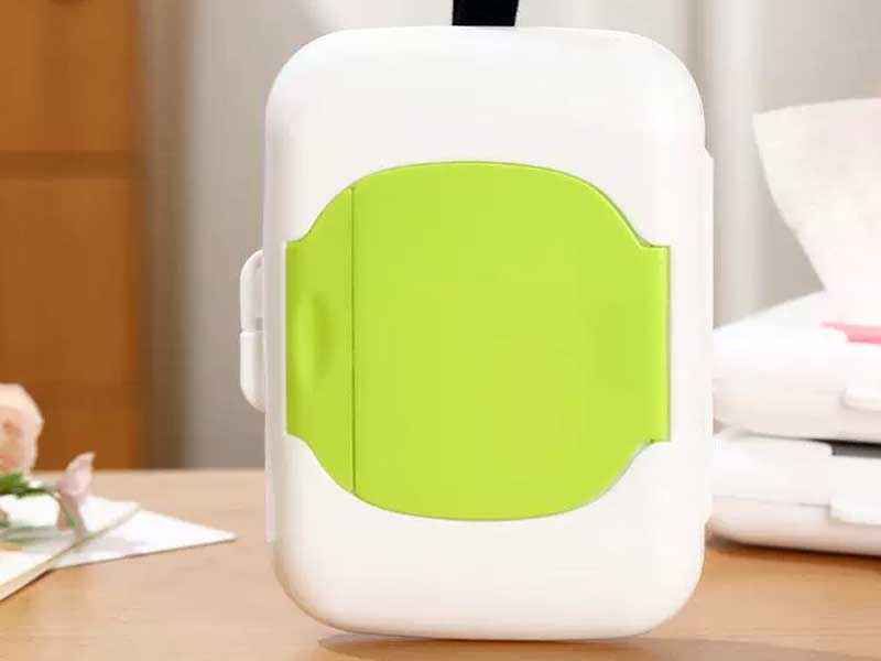 A durable and stylish silicone travel wet wipes pouch being carried by a woman on the go, showcasing portable private label tissue packaging solutions.