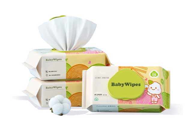 A stack of cotton-based biodegradable baby wipes with a natural raw cotton boll, highlighting soft and premium fabric for sensitive infant skin. 