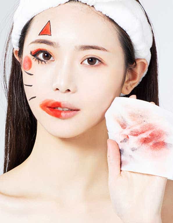A young woman using a soft facial cleansing cloth to dissolve heavy cosmetics, demonstrating Sywipe's skin-friendly makeup remover wipes formulation for daily skincare routines.