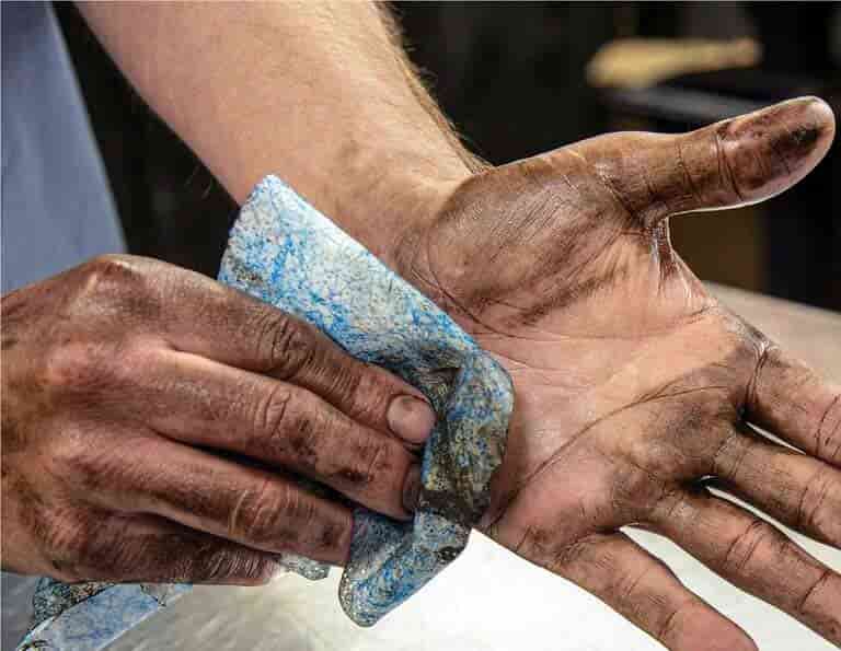 Skin-friendly industrial hand wipes scrubbing away stubborn engine oil, thick grease, and heavy grime after work.