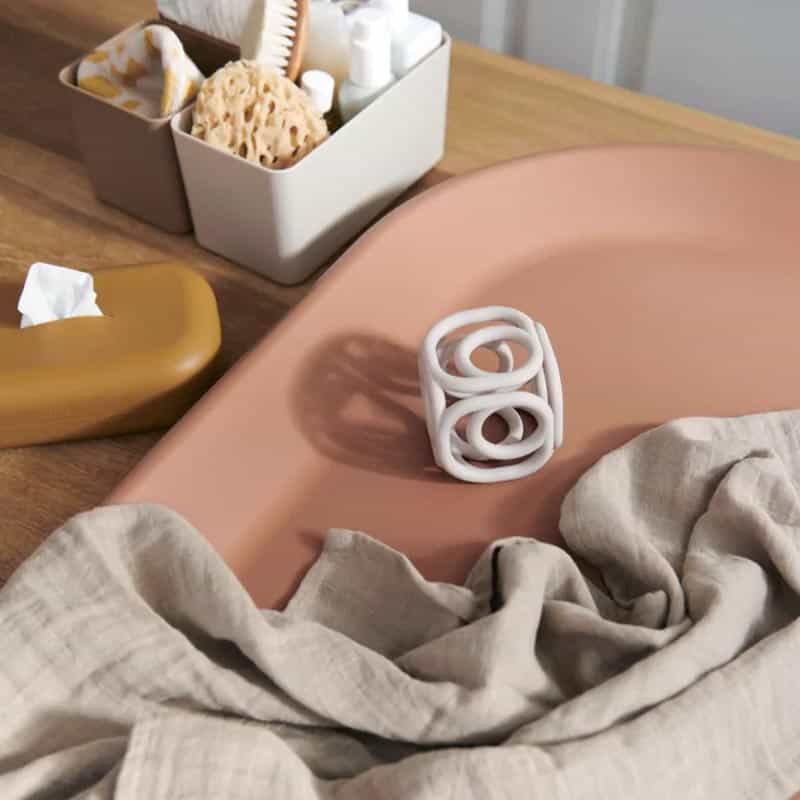 Reusable silicone wipes pouch placed on a modern baby diaper changing table with nursery decor