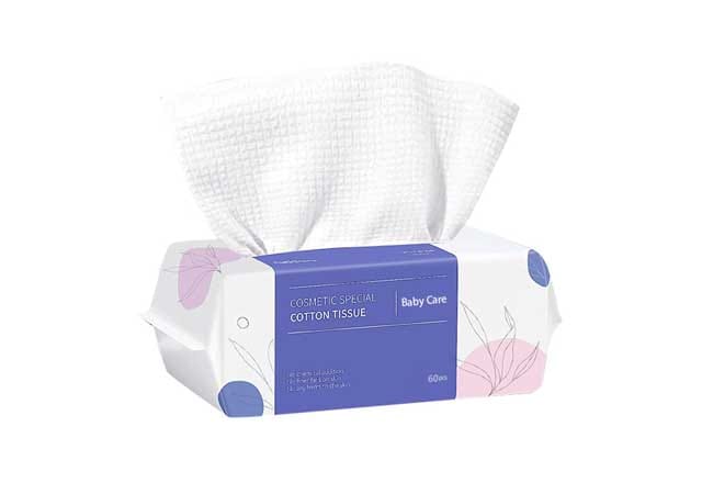 Disposable cotton face towel with textured pearl pattern in white and purple pack from OEM factory.